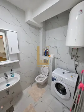 Modernly equipped bathroom with a washing machine. - image 5