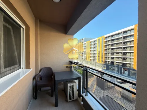 Covered balcony with seating set and a view of the buildings. - image 7