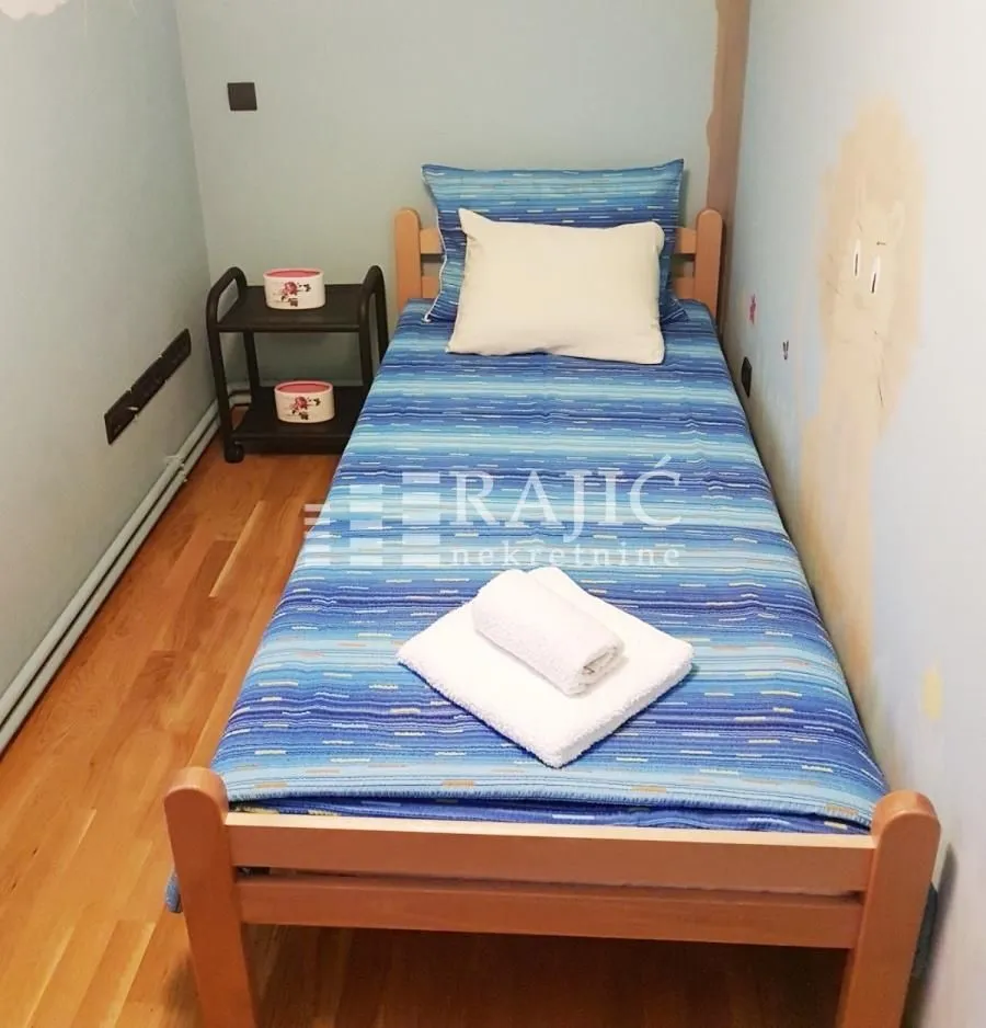 Children's bedroom with a single bed and a nightstand.