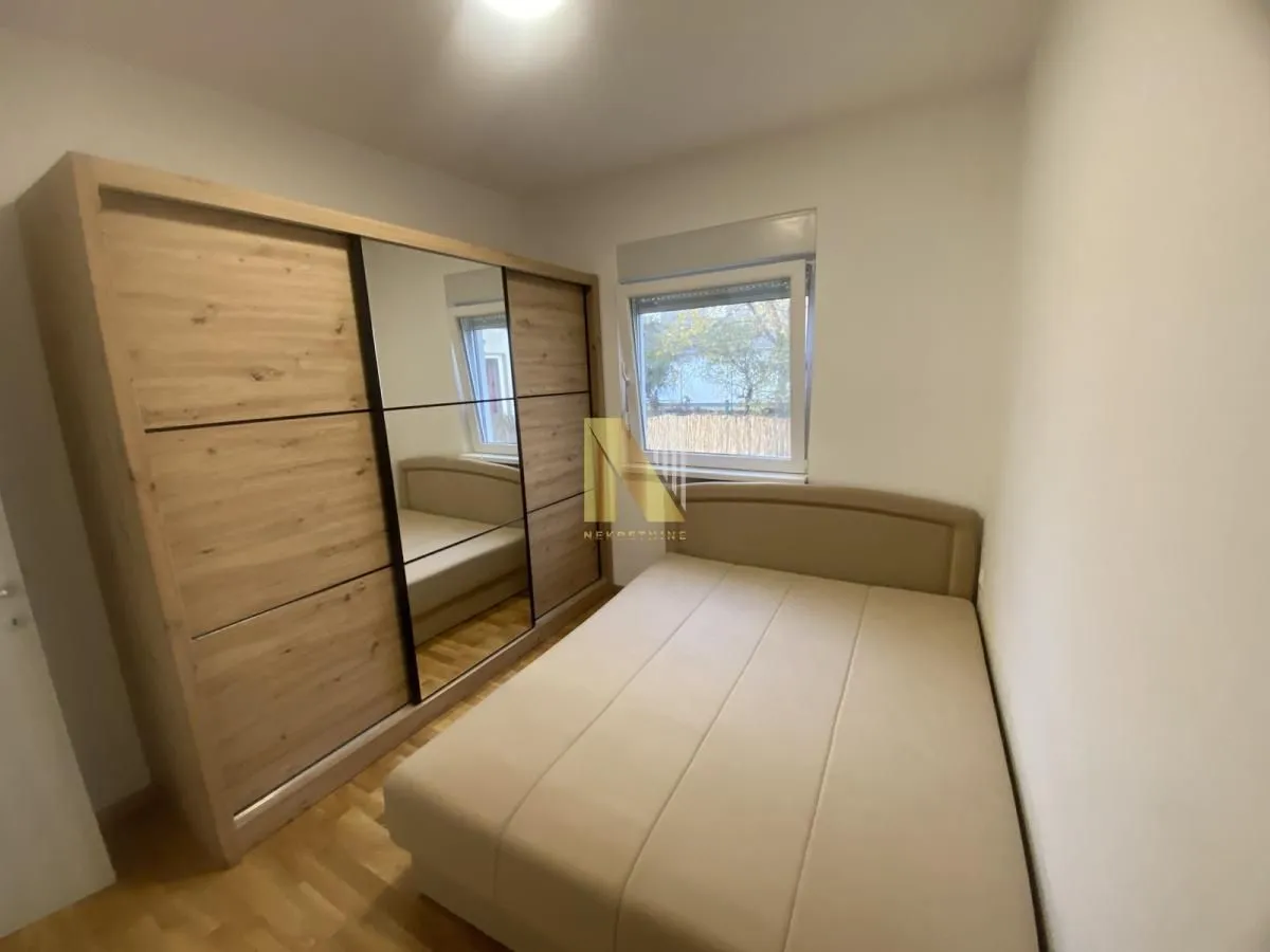 Bedroom with a double bed and a large mirrored wardrobe.
