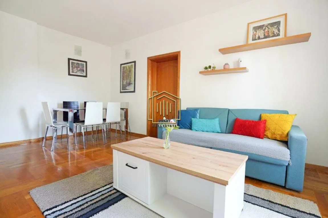Living room with a sofa set and a dining area.