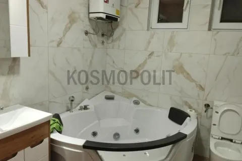 Bathroom equipped with a corner whirlpool bathtub, washbasin, and toilet. - image 8