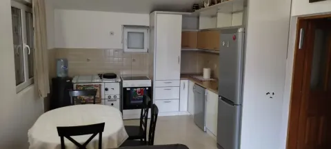Kitchen with a dining table and fitted units. - image 9
