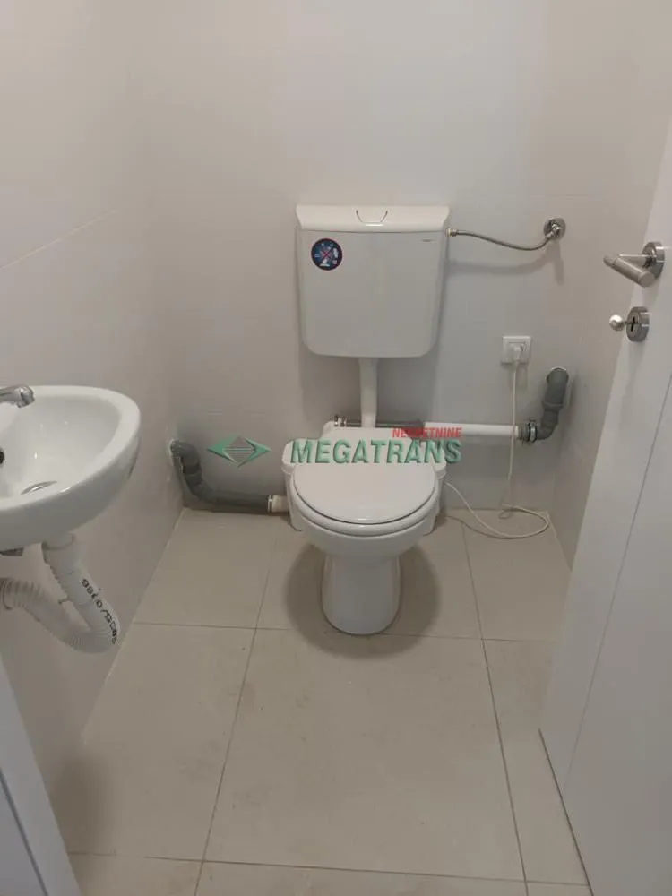 Smaller bathroom with a toilet and a sink.