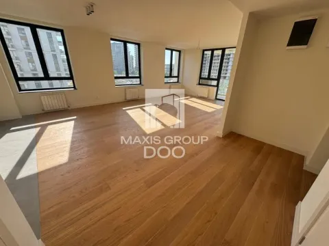 Empty room with wooden flooring and large windows. - image 2