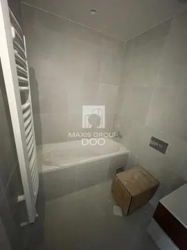 Newly equipped bathroom with a bathtub and a towel warmer. - image 2