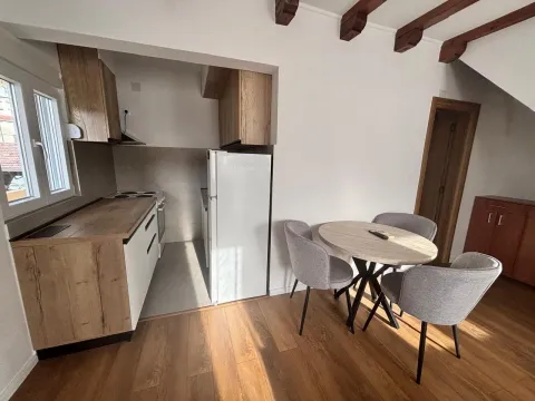 Small kitchen with a dining table and chairs. - image 3