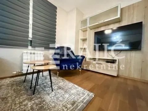 Living room with seating area, TV and coffee table. - image 2