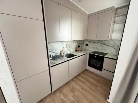 Modern kitchen with beige cabinets and a marble countertop. - image 3