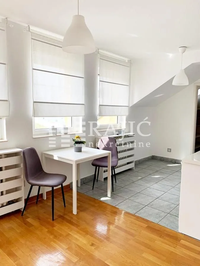 Bright dining room with a table, chairs, and windows.