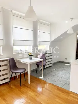 Bright dining room with a table, chairs, and windows. - image 16