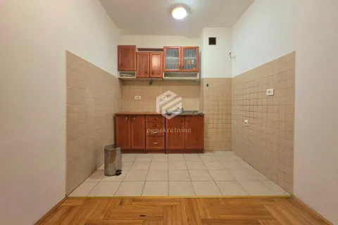 Smaller kitchen with wooden cabinets and ceramic wall tiles. - image 12