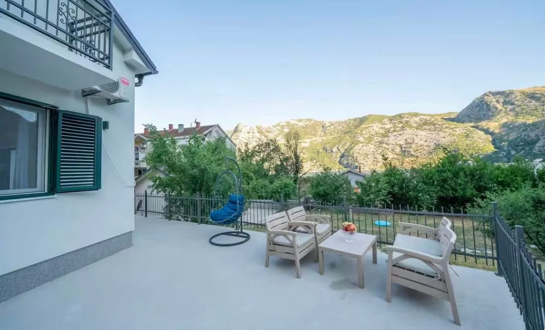 Spacious terrace with patio furniture and mountain views.