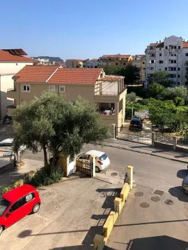 View from the window showing surrounding buildings, street, and yard. - image 14