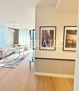 View from the hallway into a bright living room. - image 7