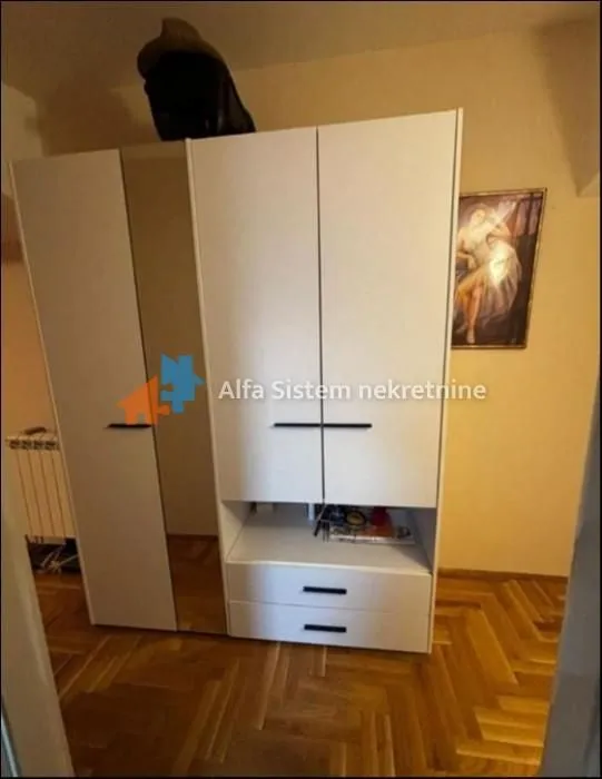 White wardrobe with a mirror in the bedroom.