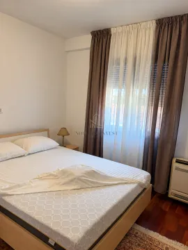 Bedroom with a double bed and a window with curtains. - image 5