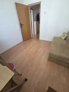 Smaller room with a bed and laminate flooring. - image 8