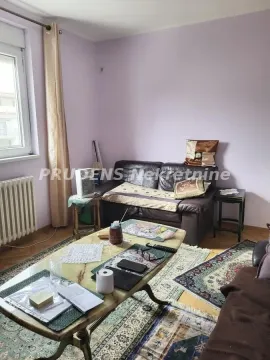 Living room with a sofa, coffee table, and a window. - image 4