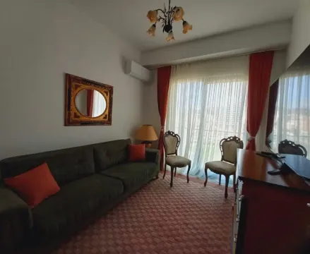 Living room with sofa, small table and access to the terrace. - image 13