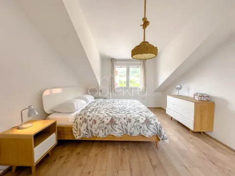 Bright and spacious bedroom with a double bed and wooden flooring. - image 10