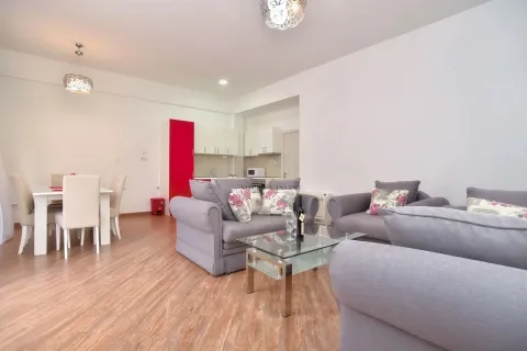 Spacious living room with seating area, dining space and kitchen in the background. - image 3