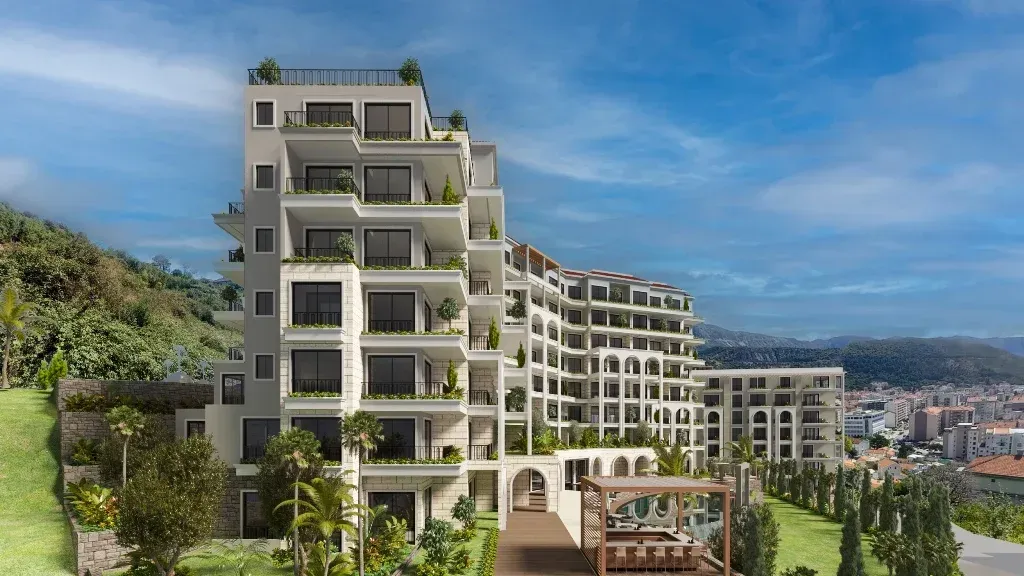 Exterior view of the residential building with landscaped yard and terraces.