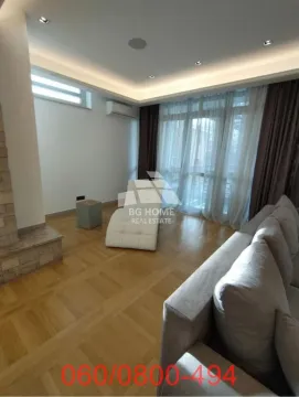 Living room with furniture and large windows letting in natural light. - image 2