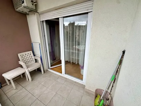 Small balcony with plastic chairs and cleaning supplies. - image 6