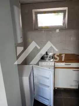 Small kitchen with a sink, refrigerator, and cabinetry. - image 4