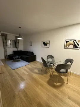 Living room with a corner sofa and a dining table. - image 3