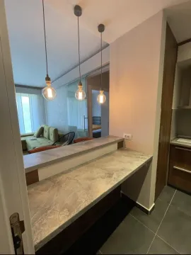 View from the kitchen with a breakfast bar and pendant lights towards the living room. - image 5