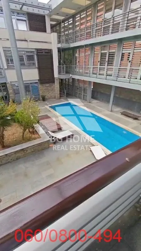 Interior courtyard of the building with a swimming pool and galleries.