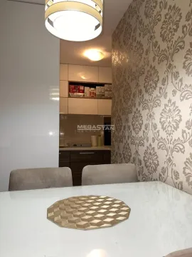 Dining table in the foreground with a view of the kitchen in the background. - image 9