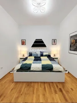 Bedroom with a double bed, nightstands, and wooden flooring. - image 8