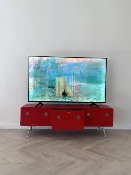 Televizor na crvenoj komodi u dnevnoj sobi. - image 6