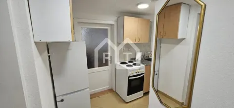 Small kitchen with a stove, refrigerator, and wooden cabinetry. - image 4