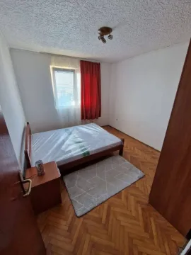 Furnished bedroom with a bed and parquet flooring. - image 3