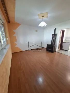 Empty living room with wooden flooring and a wood stove. - image 3