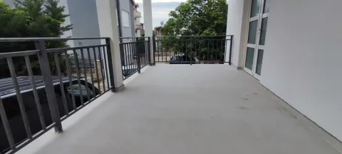 Spacious unfurnished balcony with metal railing and surrounding view. - image 7