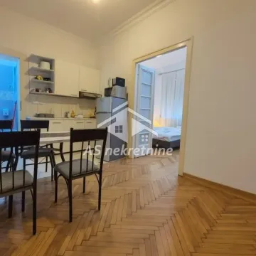 Kitchen with dining area and a view of the adjacent room. - image 10