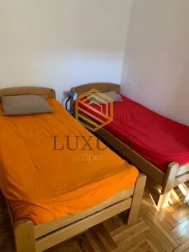 Bedroom with two wooden beds. - image 4