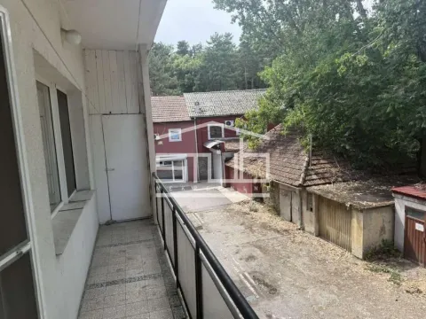 Long balcony with a view of the courtyard and surrounding buildings. - image 4