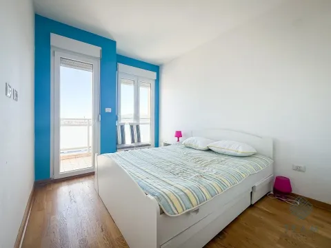 Bedroom with a double bed, a blue accent wall, and access to the balcony. - image 5