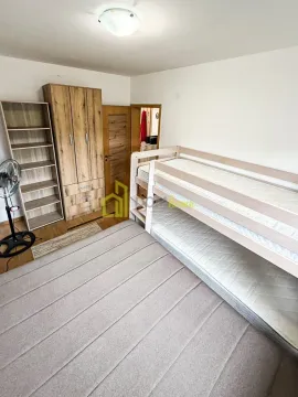 Bedroom with a bunk bed and a wooden wardrobe. - image 6