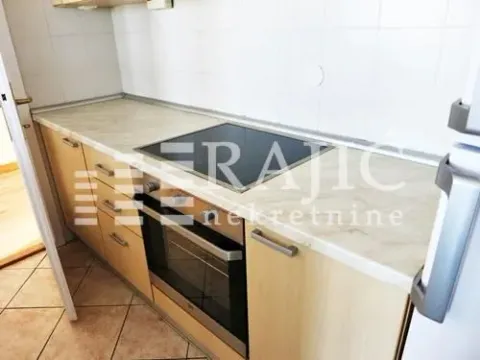 A view of a partially equipped kitchen with a built-in hob and oven. - image 2