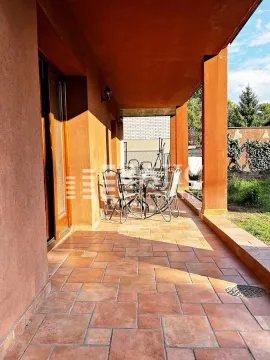 Covered terrace with ceramic tiles and patio furniture. - image 5