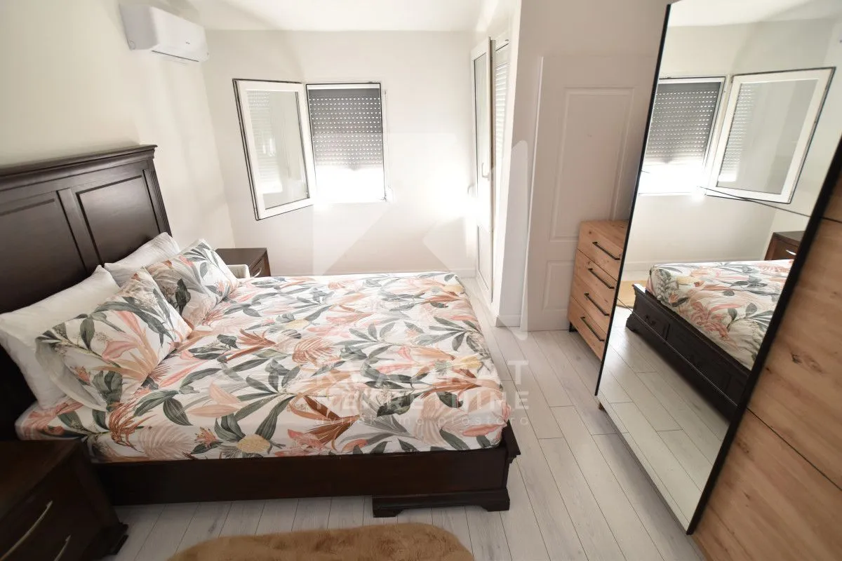 Furnished bedroom with a double bed, wardrobe, and air conditioning.