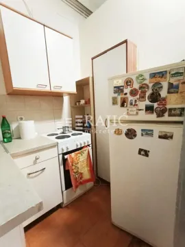 Small kitchen with basic elements and a refrigerator. - image 7