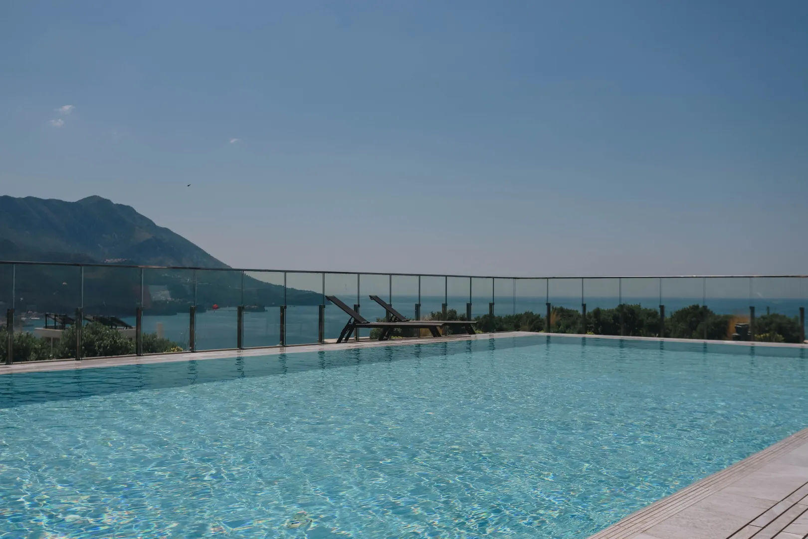 Swimming pool with a view of the sea and mountains.